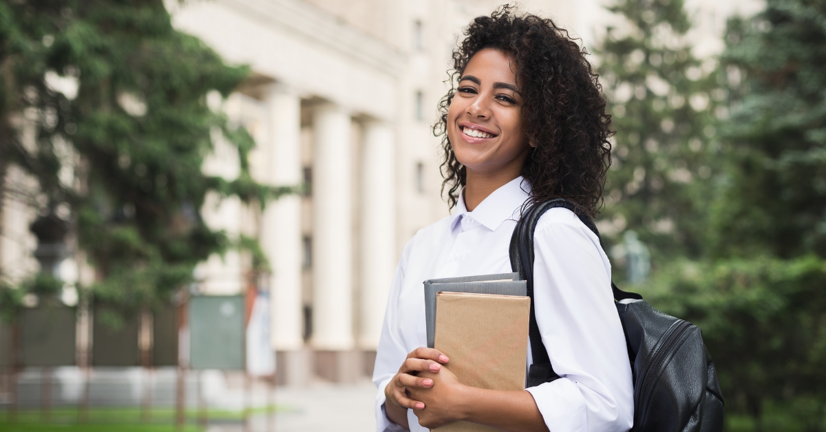 Student holding books at campus