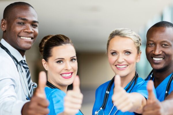 Group of healthcare professions giving the thumbs up