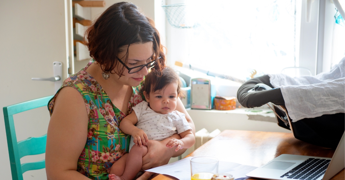 baby on the lap of a mom at the dining table