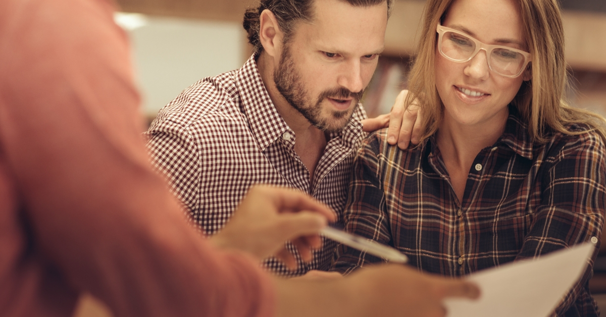 couple looking at a paper showing their credit score